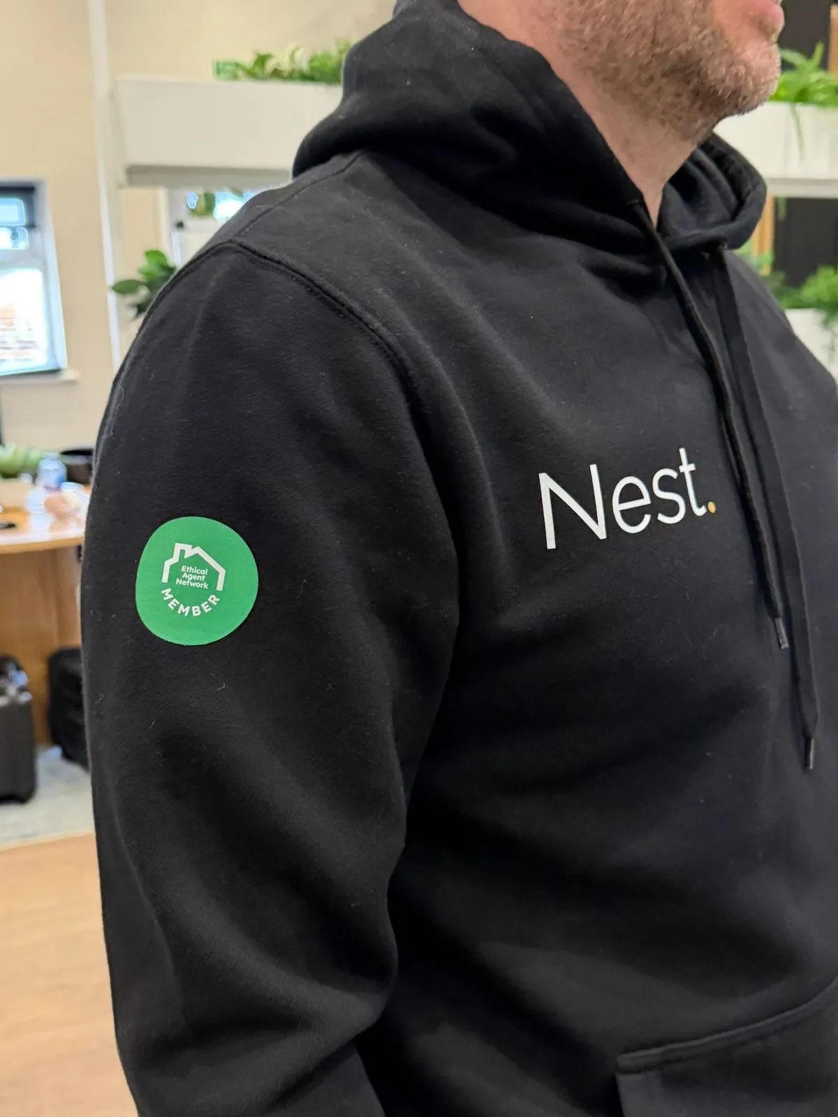 The Ethical Agent Network member badge sewn onto the sleeve of a member agency hoodie