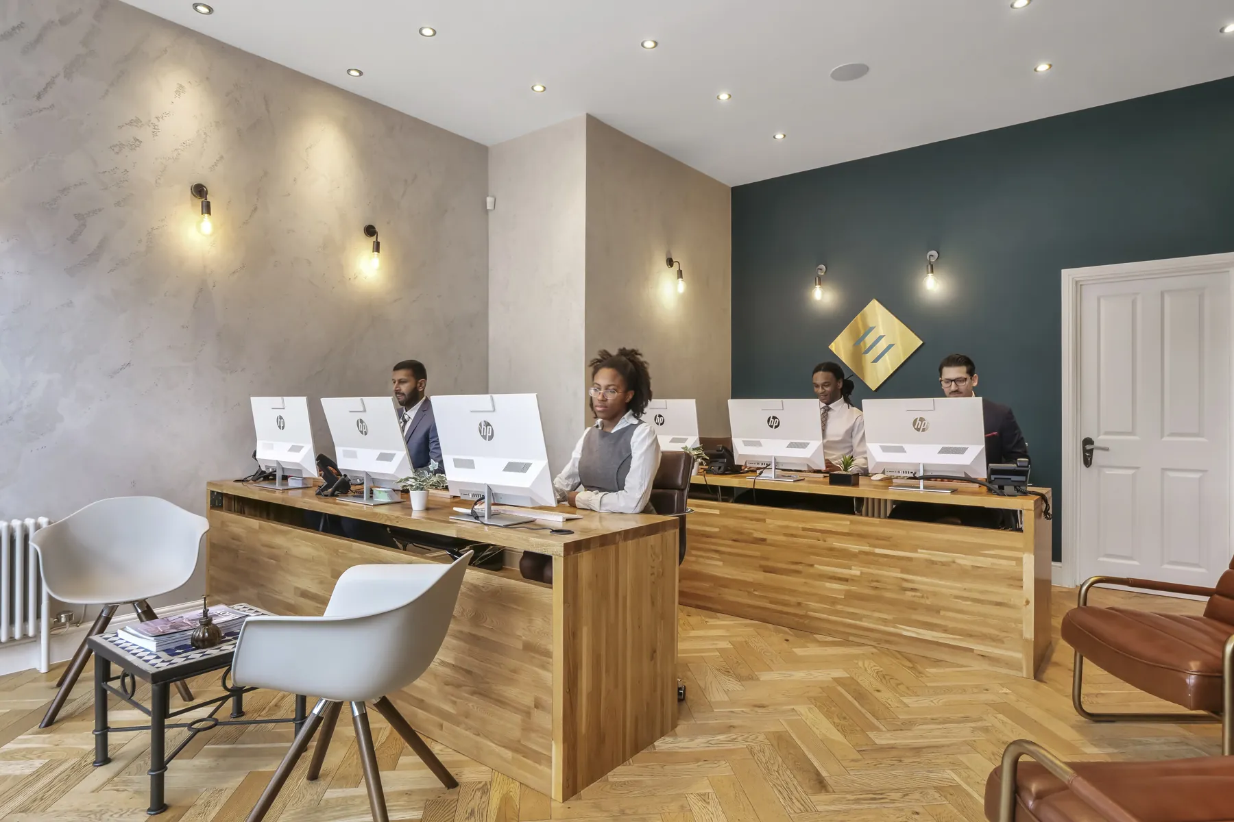 The interior of an estate agency office with staff working at desks
