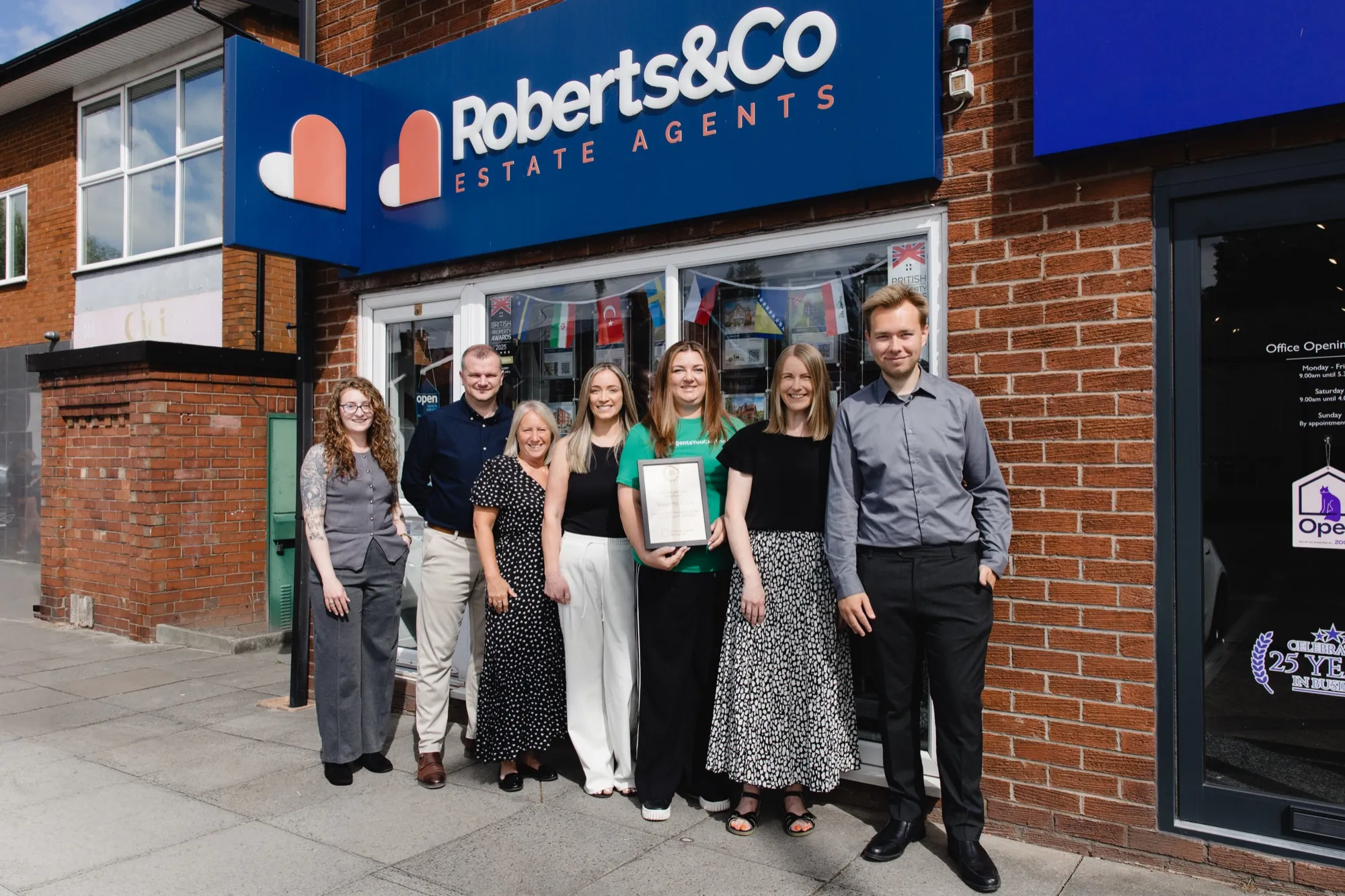 The team of an approved member agency outside their own office holding their Ethical Agent Network certificate