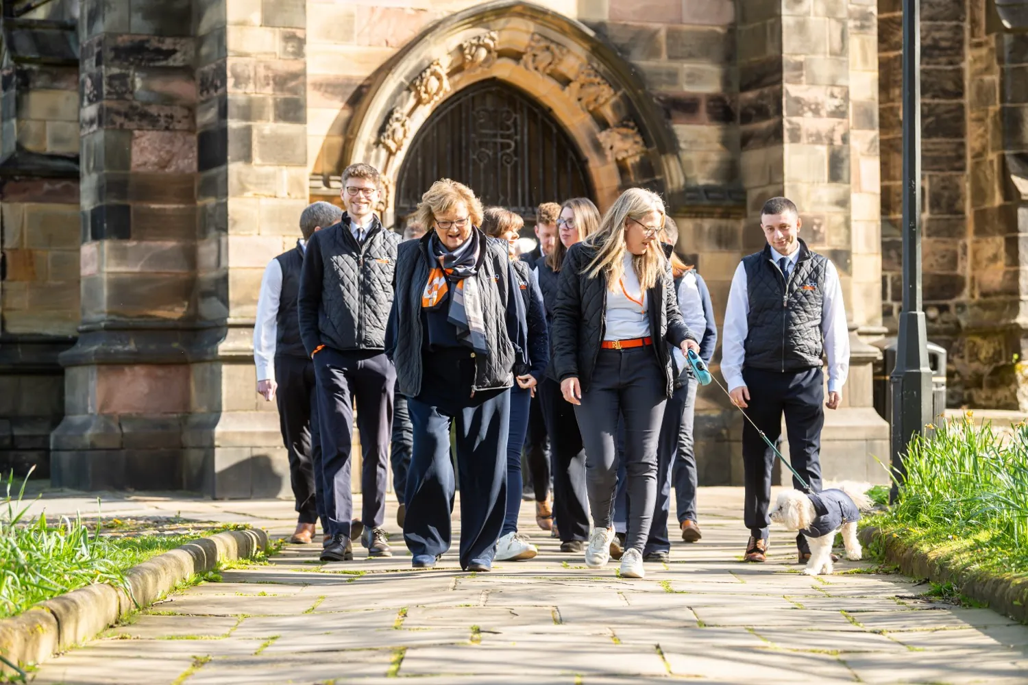 A member agency team walking together past a church