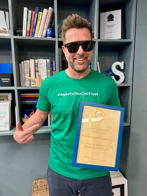 A member of Paramount Properties wearing the network's Agents You Can Trust shirt